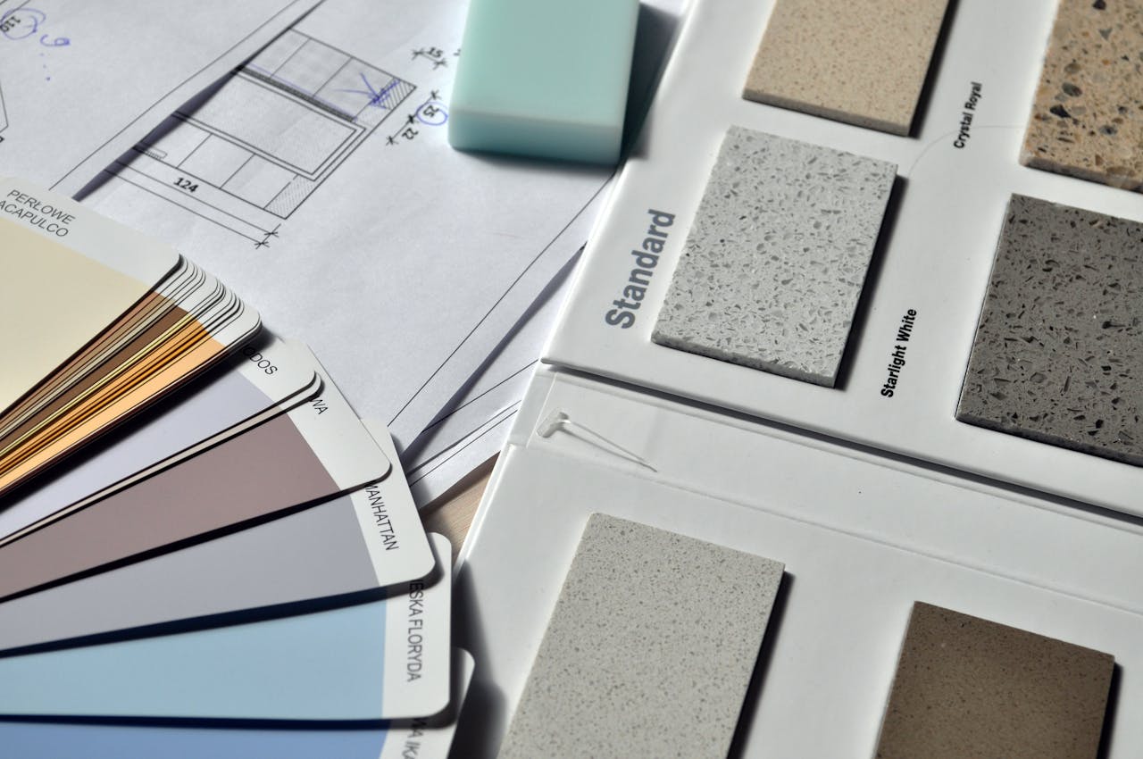 services-03 Color palette and material samples for interior renovation projects on a blueprint.